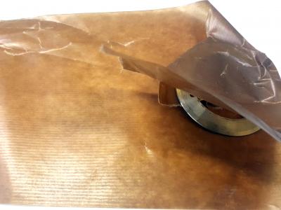 Brown wax paper with a metal object