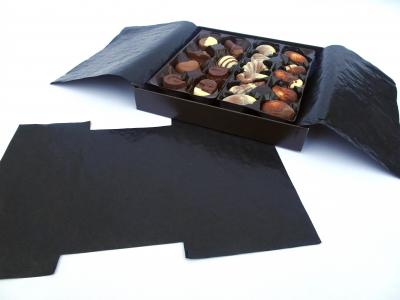 Black cristal paper inside of a chocolate box